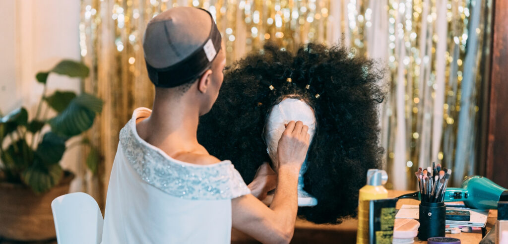 Hairstylist dressing a wig during professional wig styling training