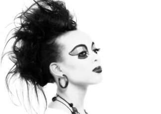 Black and white photo of a model with striking make up