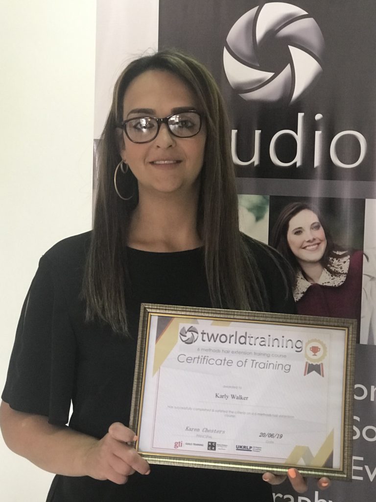 Hair extension student receiving her certificate.